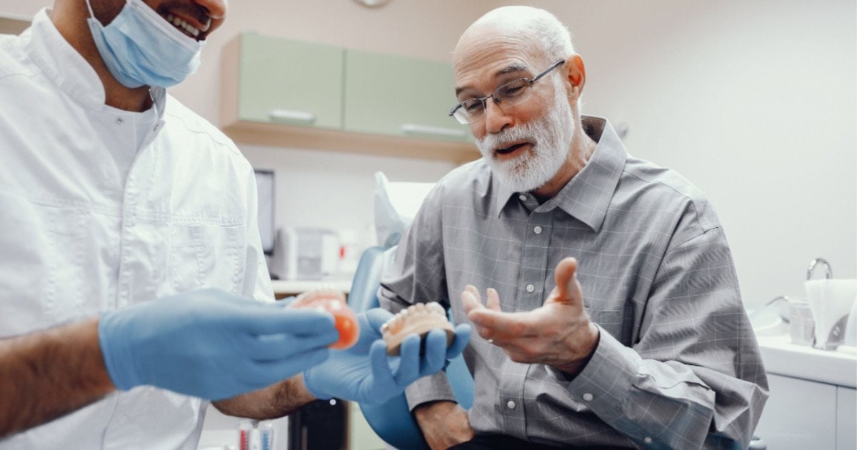 Dentist discussing denture options with a patient in Belmont WA